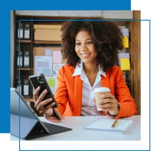 Woman looking at phone and iPad with coffee