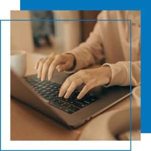 A woman typing on a laptop