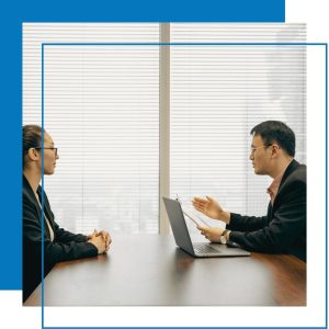 Two people talking to each other across a table