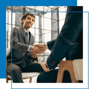 Two men shaking hands sitting down